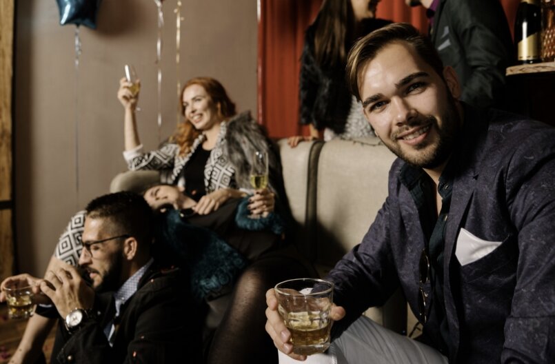 Dressed-up guests relaxing and celebrating together in a lounge
